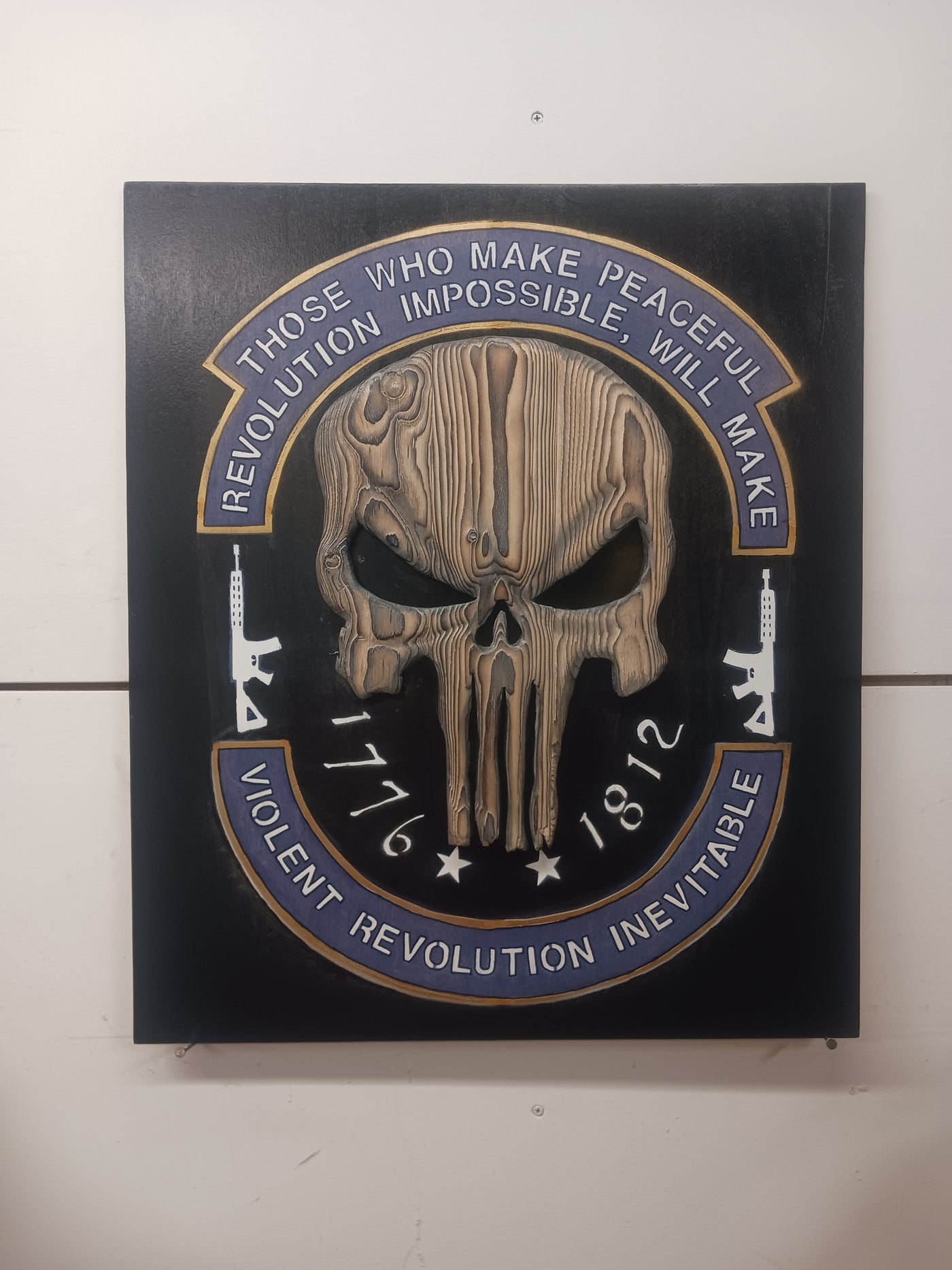 Wooden plaque featuring a skull and the phrase the revolution is coming designed as Punisher-themed wall art